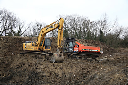 Digger and a tracked dumper removing more of the clay capping - Mike Hopps - 5 March 2011
