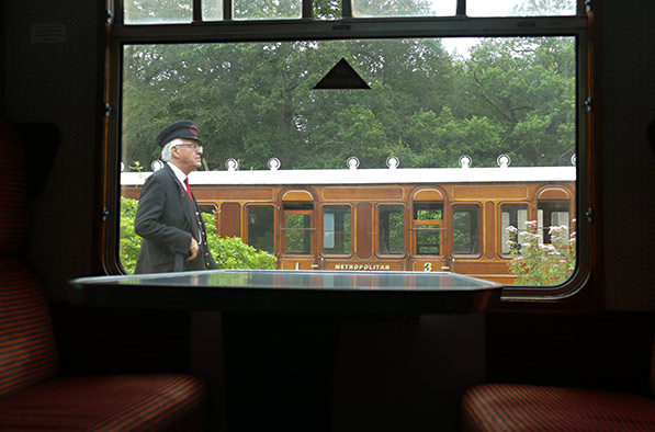 Met carriage and station staff at Horsted framed by Bulleid Carriage window - John Sandys - 2 August 2021